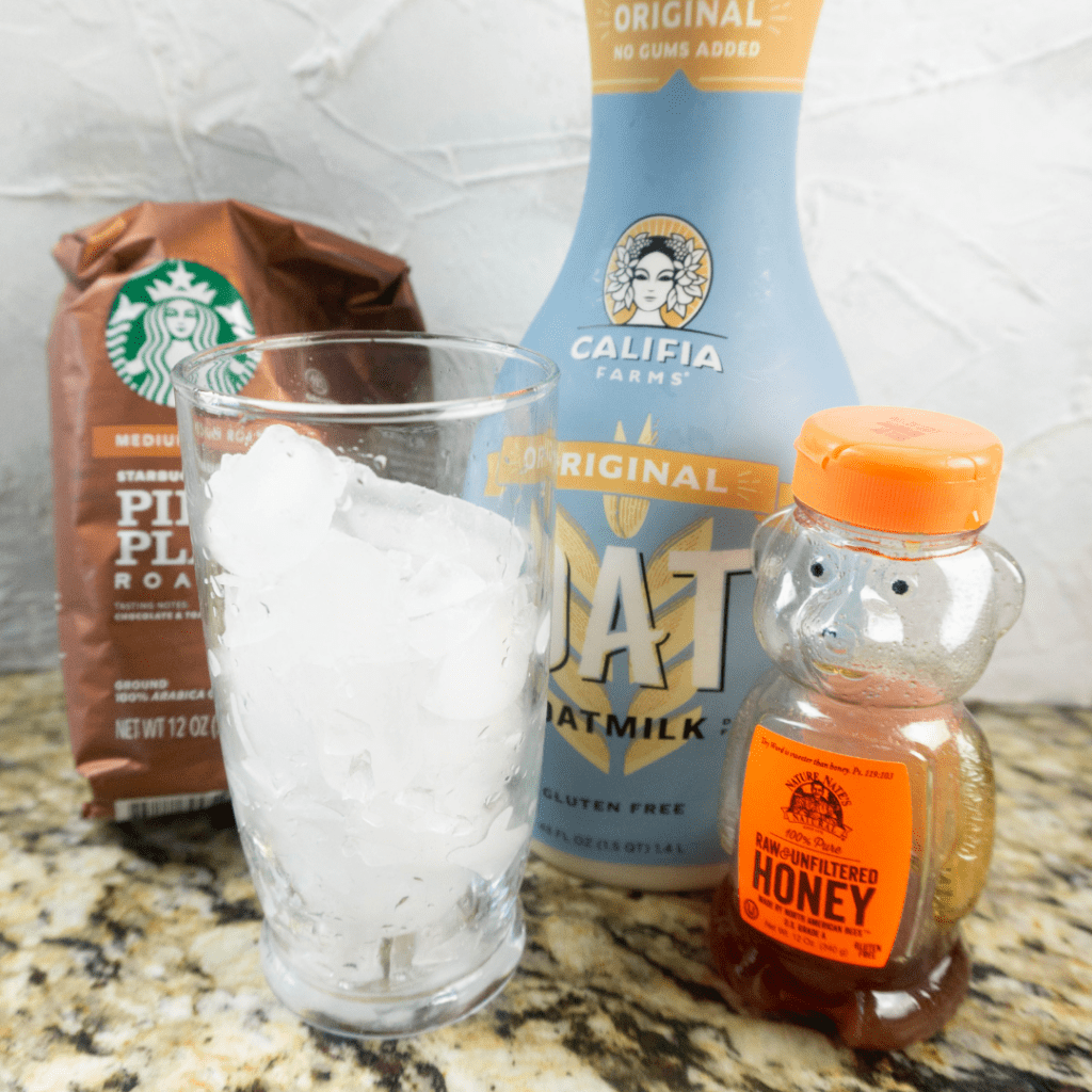 ingredients to make an iced honey oatmilk latte